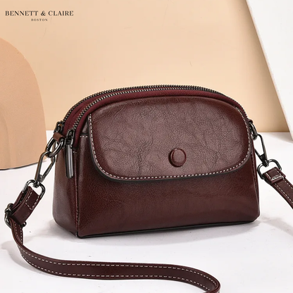 Deep burgundy-brown version of the crossbody bag, with cream stitching along the flap and the long strap. 3