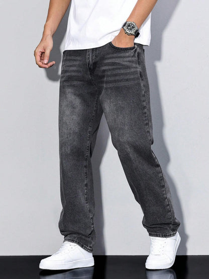 Faded charcoal-black loose jeans worn by a model with hand in pocket, showing whiskering at the hip. 7