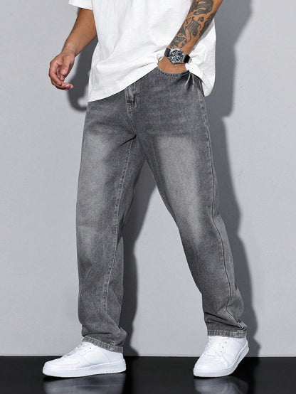 Three-quarter front view of grey faded wide-fit jeans worn with a white t-shirt, watch and white trainers, hand in the front pocket. 2