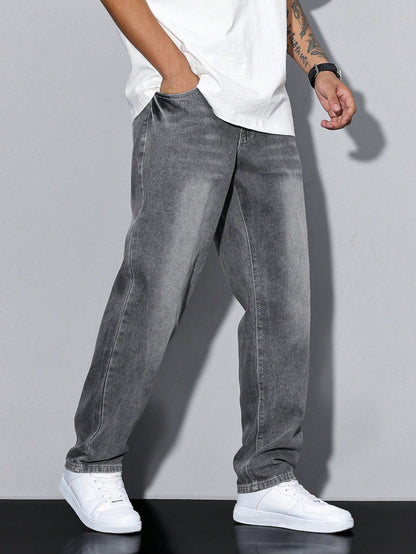 Model walking in grey washed baggy jeans, seen from the left side with a hand in the pocket and white trainers. 3