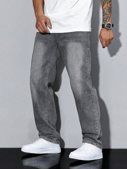 Front view of loose grey faded jeans with contrast stitching, worn with a white t-shirt, black watch and white trainers. 5