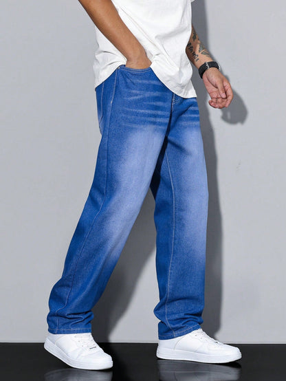Side view of bright blue gradient-washed baggy jeans with light fading on the thighs, worn with a white t-shirt and trainers. 8