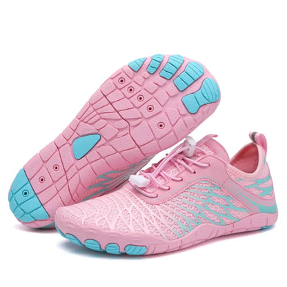 Pair of pink barefoot shoes with turquoise accents, one turned over to show the turquoise toe pads on the sole. 8