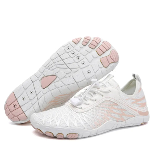 White and pale pink mesh barefoot shoes, one upturned to show the sole with pink toe pads, the other standing upright. 1