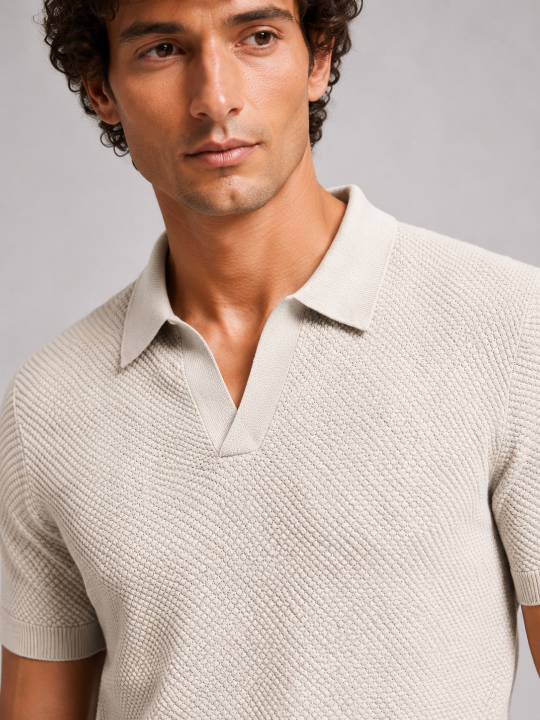 Close-up of off-white knit polo showing the open collar and basketweave-style texture 17