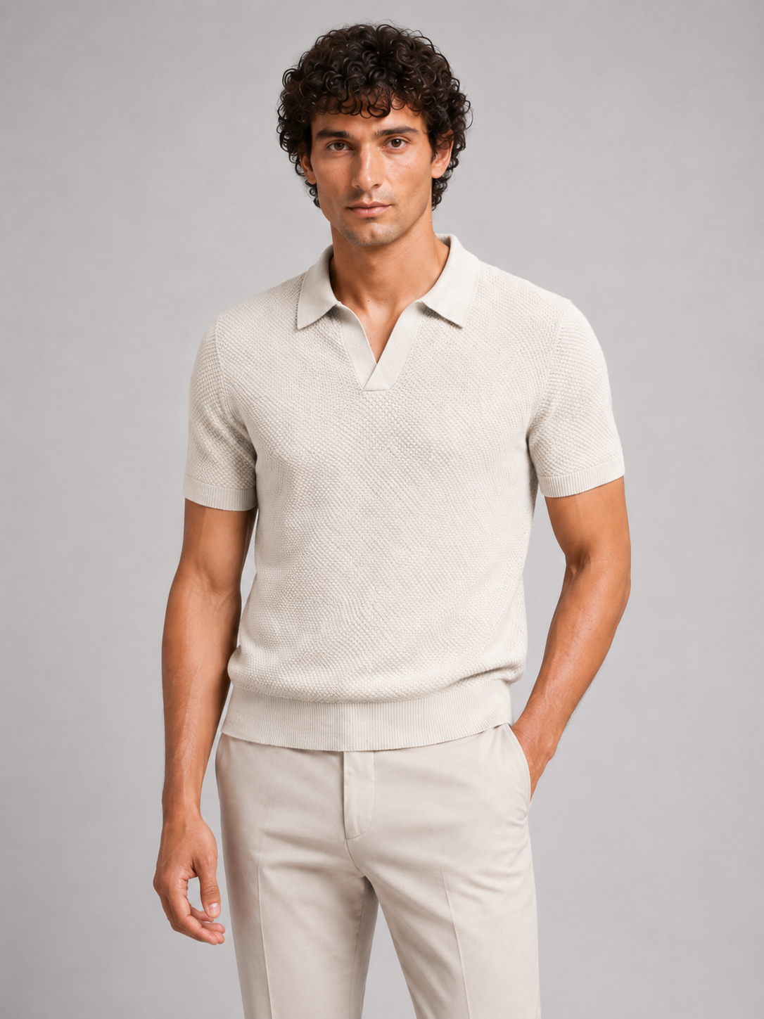Model in off-white textured knit polo with open collar and beige trousers, front view 16