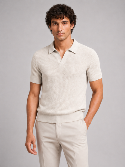 Model in off-white textured knit polo with open collar and beige trousers, front view 16