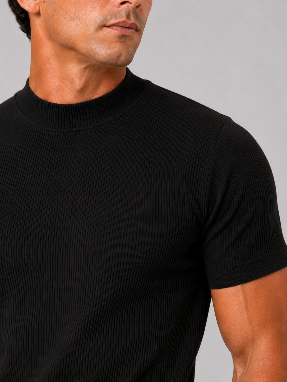 Close-up of the black top showing fine vertical ribbing, mock neck collar and short sleeve hem. 17