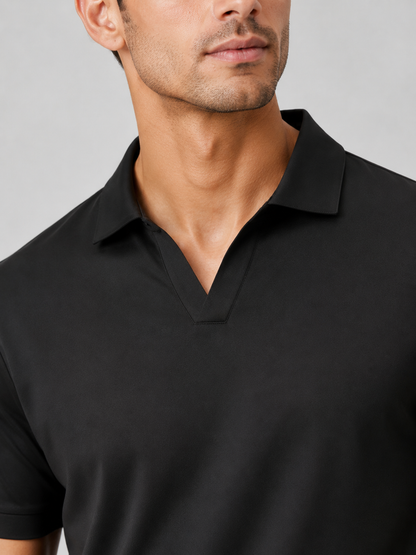 Close-up of the black polo's V-shaped neckline and folded collar, showing the smooth stitched placket on a grey background. 7