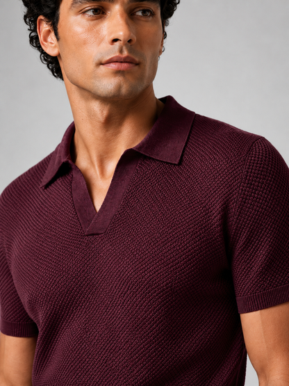 Close-up of burgundy knit polo showing the textured honeycomb stitch, open V-neck collar and ribbed sleeve cuff 22