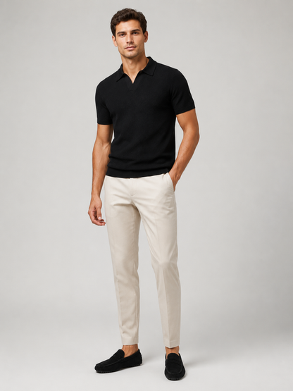 Full-length front view of model in black knit polo, cream trousers and black suede loafers 8