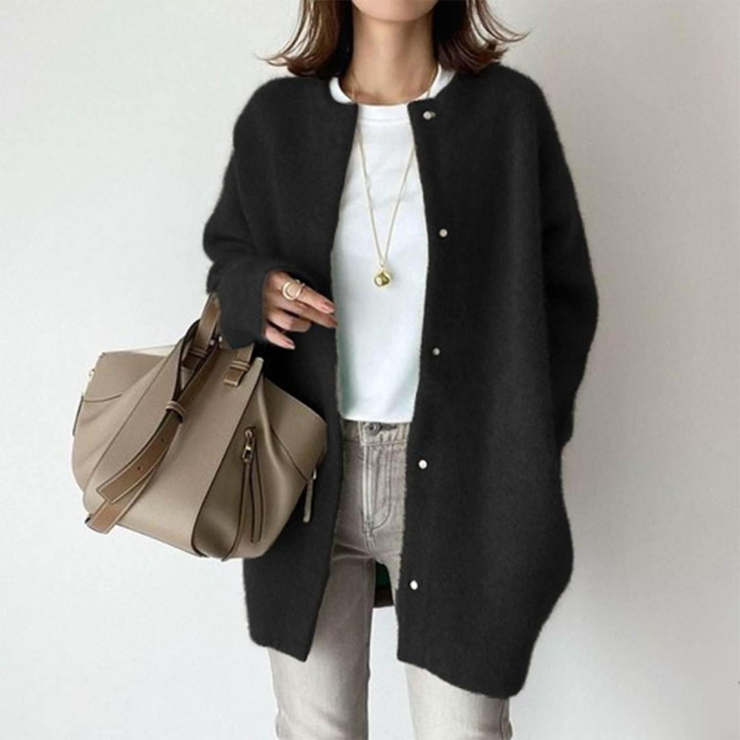 Model wears the same snap-button cardigan in black, styled with a white tee, grey jeans and a taupe handbag 4