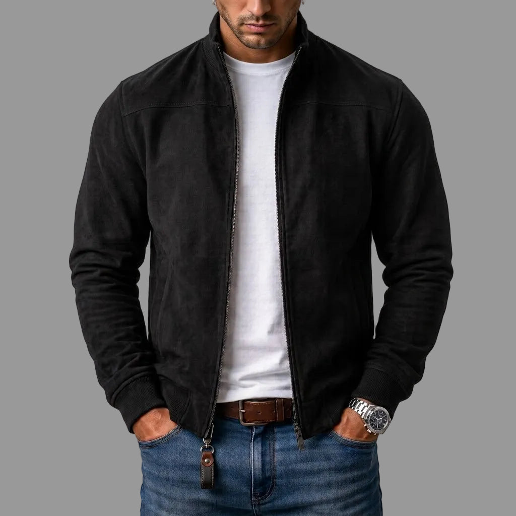 Model wears the black suede-look bomber jacket unzipped over a white T-shirt and jeans, with a leather tag on the zip pull. 1