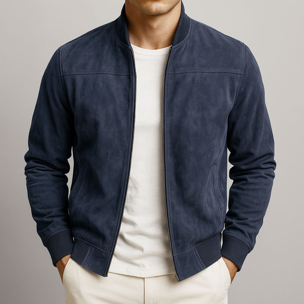 Model wearing the bomber in navy blue, zip open over a white T-shirt, hands in the trouser pockets. 5