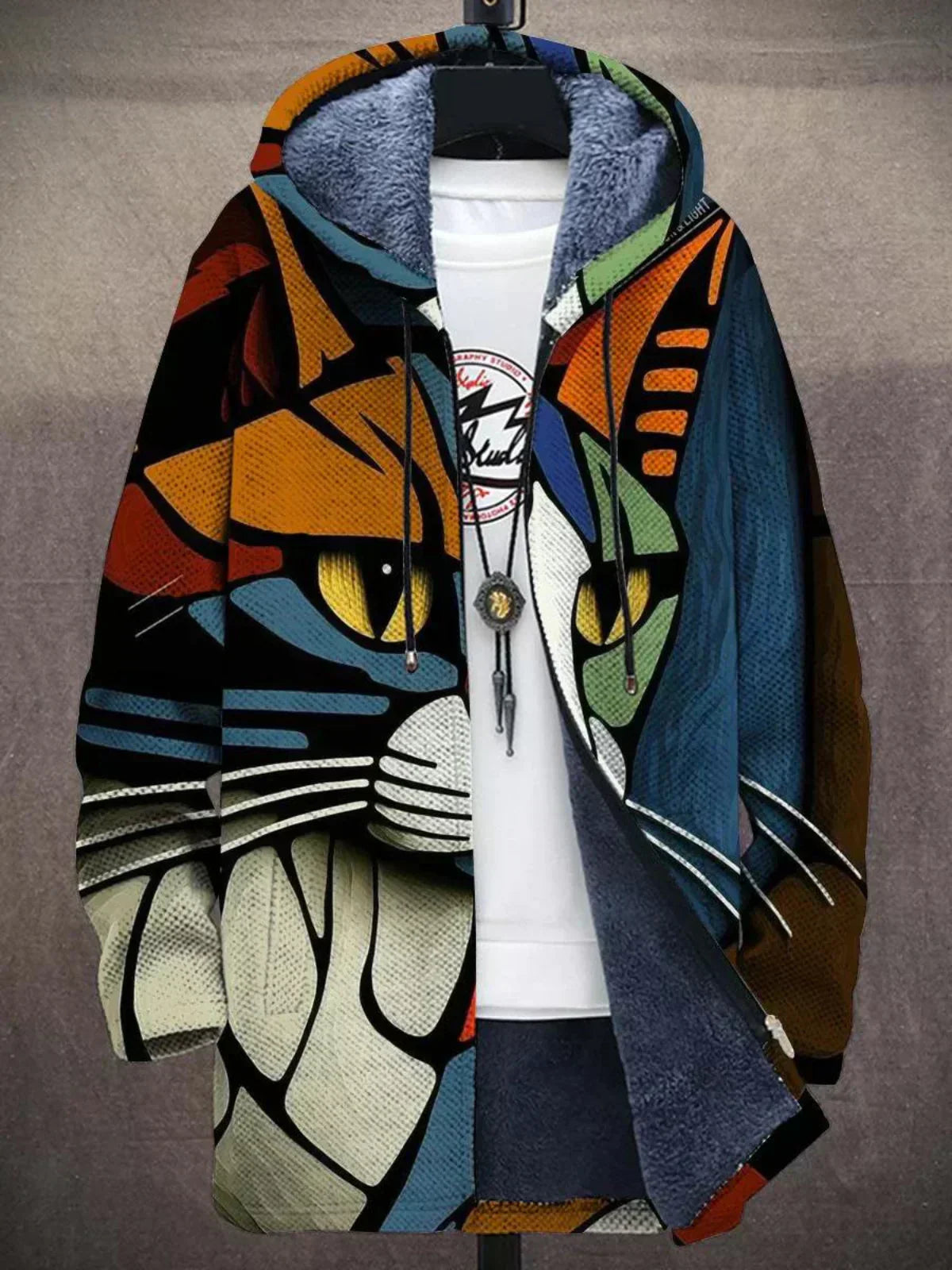 Hooded fleece-lined cardigan printed with a geometric stained-glass style cat face with yellow eyes, on a stand 4