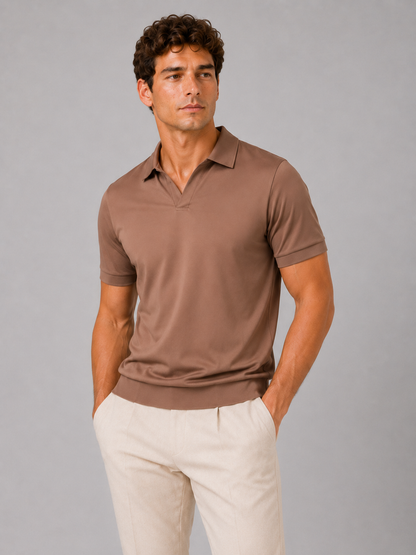 Model wearing the brown polo with a V-neck collar and ribbed hem, front view in a studio, paired with cream trousers. 11