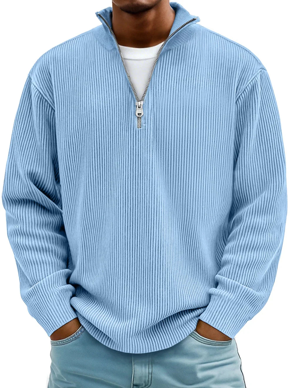 Man wearing the zip-collar ribbed sweater in light sky blue over a white tee, hands in pockets 1