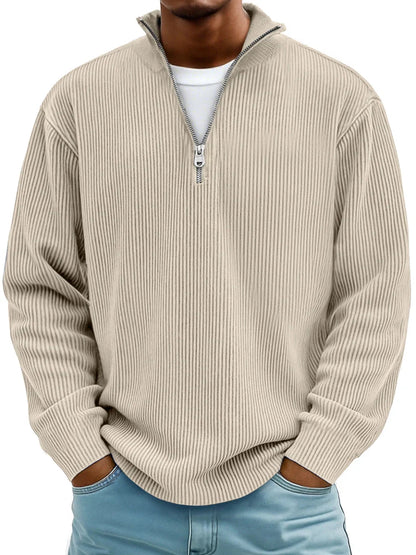 Man wearing the ribbed half-zip jumper in beige over a white tee, hands in jeans pockets, front view. 7