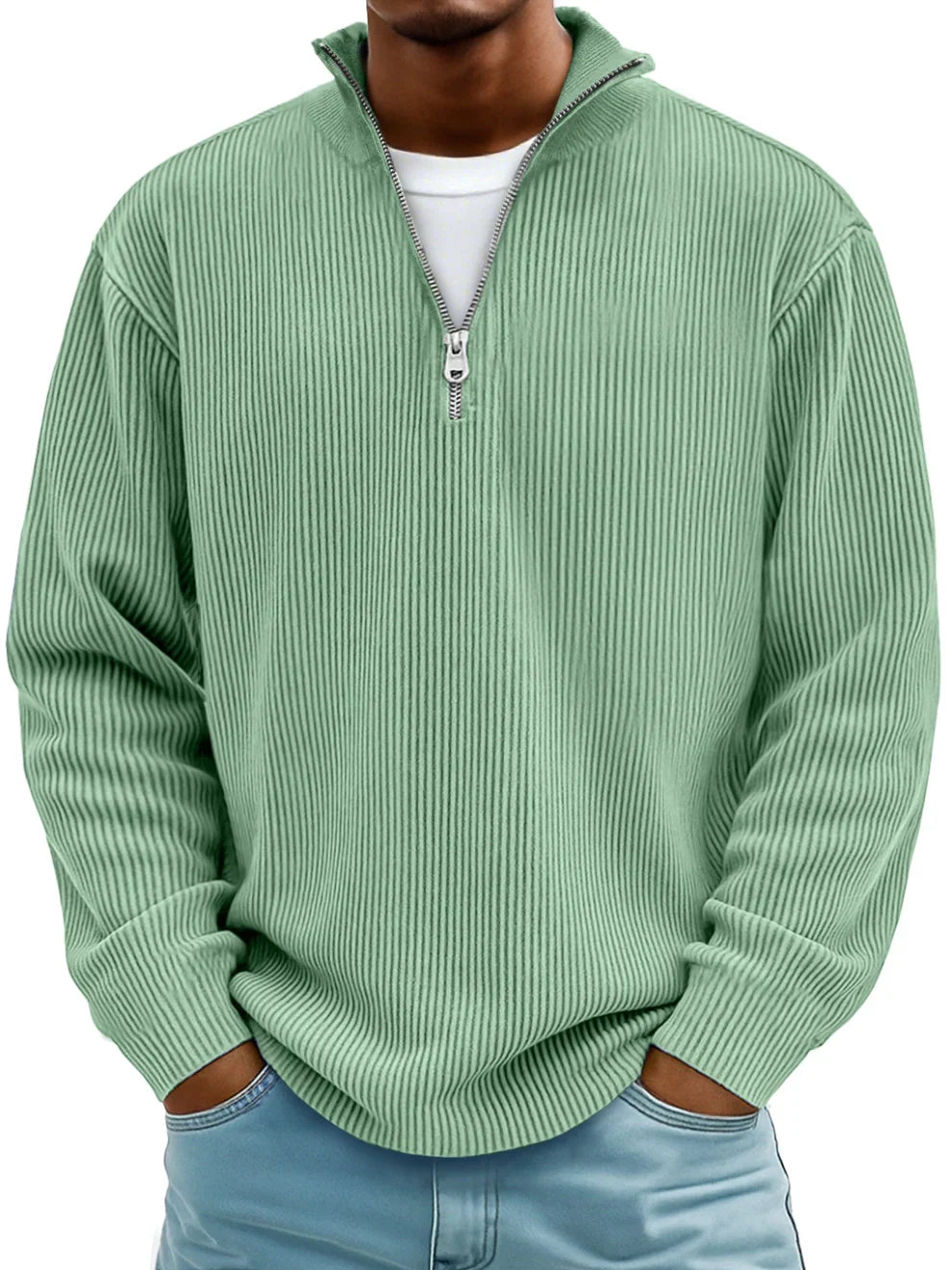 Man wearing the ribbed half-zip jumper in mint green over a white tee, hands in jeans pockets, front view. 8