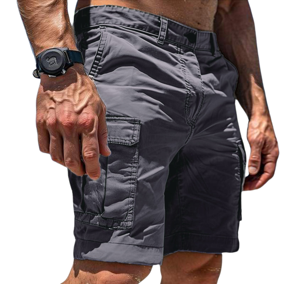 Close-up of a model wearing dark grey cargo shorts, showing the large flap side pocket, belt loops and a black wristwatch. 1