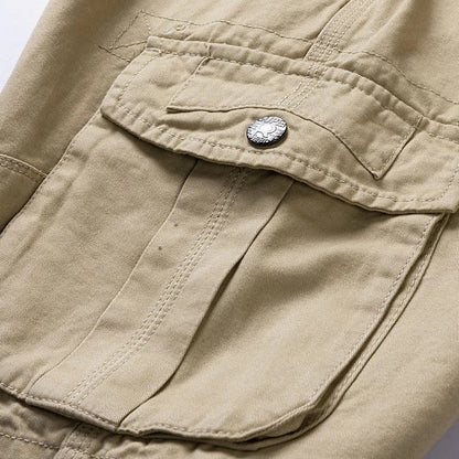 Close-up detail of a khaki cargo pocket with a buttoned flap and neat double-stitched seams. 7