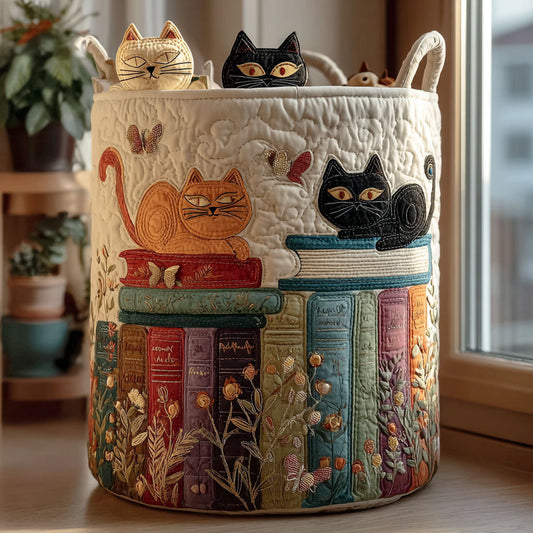 Cream quilted round basket with two handles, stitched with an orange cat and a black cat lounging on colourful book stacks, beside a sunny window. 1