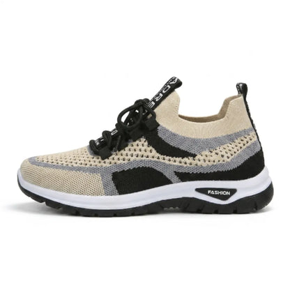 Side view of a beige, grey and black knit mesh trainer with black laces, white midsole and black outsole. 37