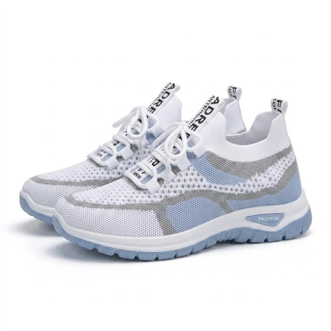 Pair of white and pale blue mesh trainers angled together, showing laces, lace loops and the thick pale blue sole. 7
