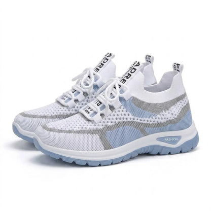Pair of white and pale blue mesh trainers angled together, showing laces, lace loops and the thick pale blue sole. 7