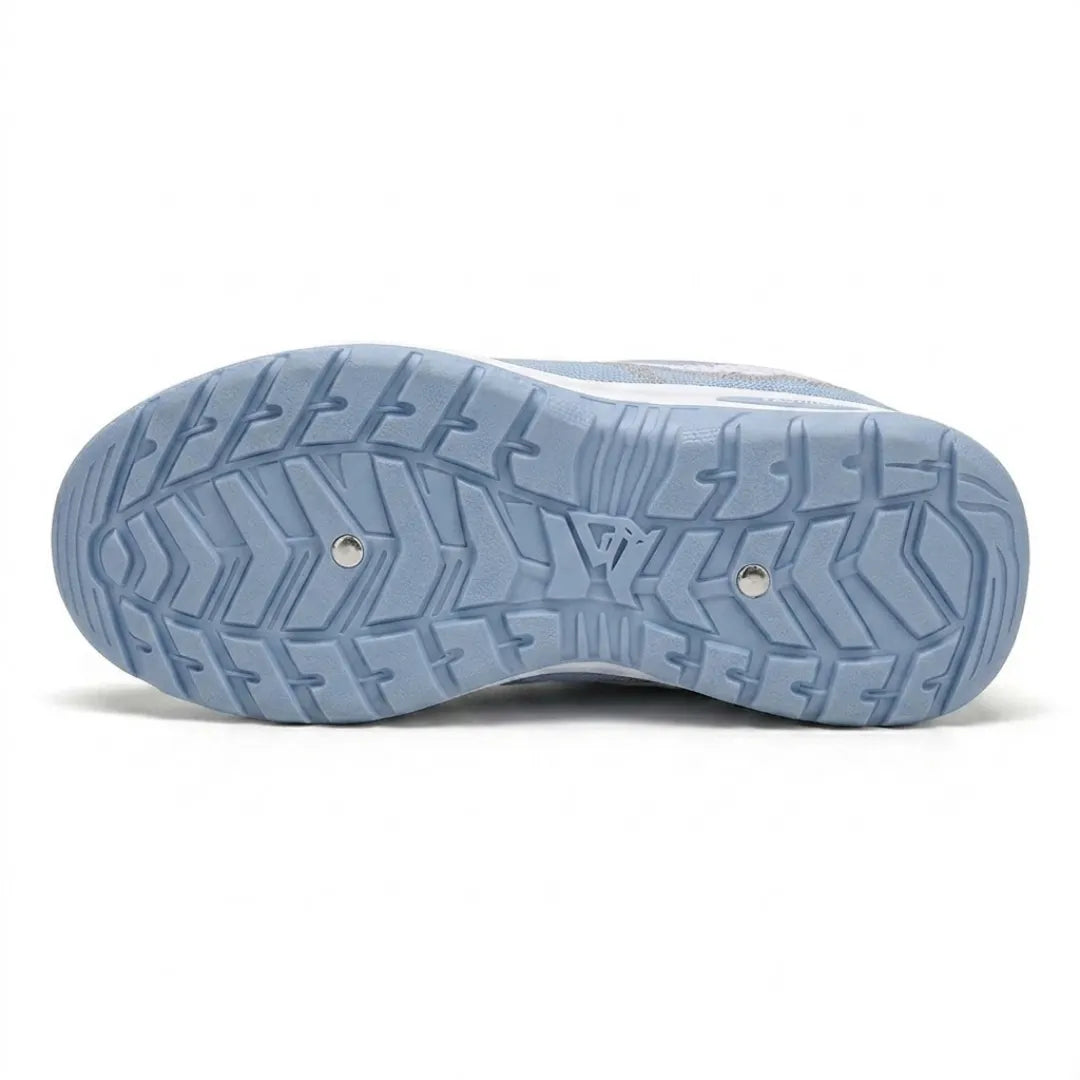 Underside of the pale blue sole, showing a deep chevron tread pattern with two small metal studs. 9