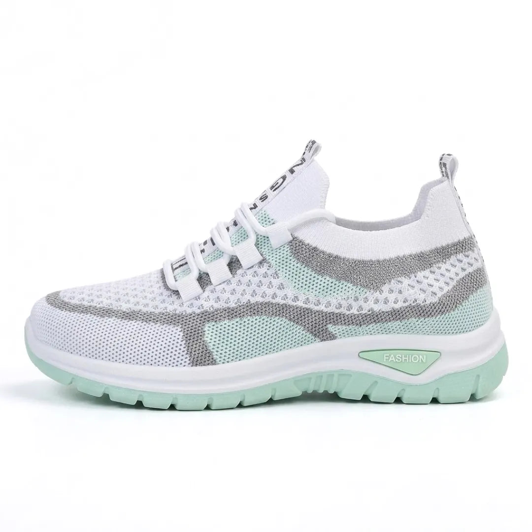 Side view of the white mesh trainer in a mint green colourway with grey overlays and a mint sole. 10