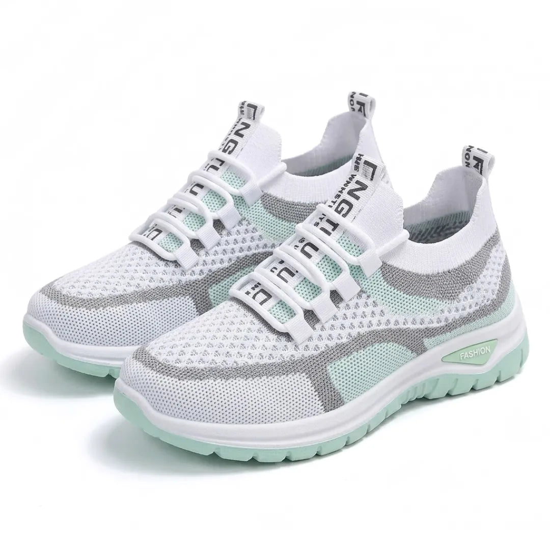 Pair of white and mint green mesh trainers angled together, showing elastic lace loops and the mint sole. 16
