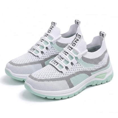 Pair of white and mint green mesh trainers angled together, showing elastic lace loops and the mint sole. 16