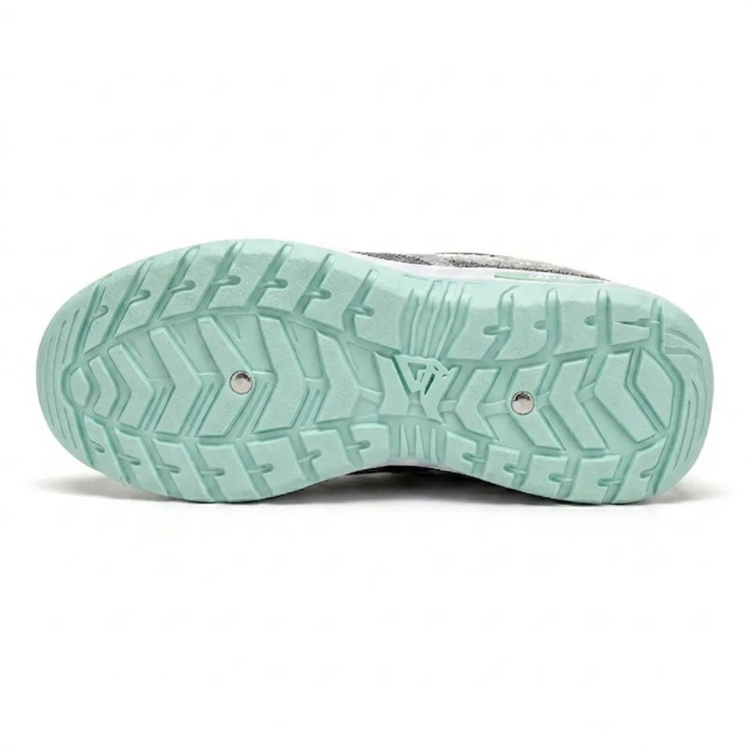 Underside of the mint green sole, showing a deep chevron tread pattern with two small metal studs. 18
