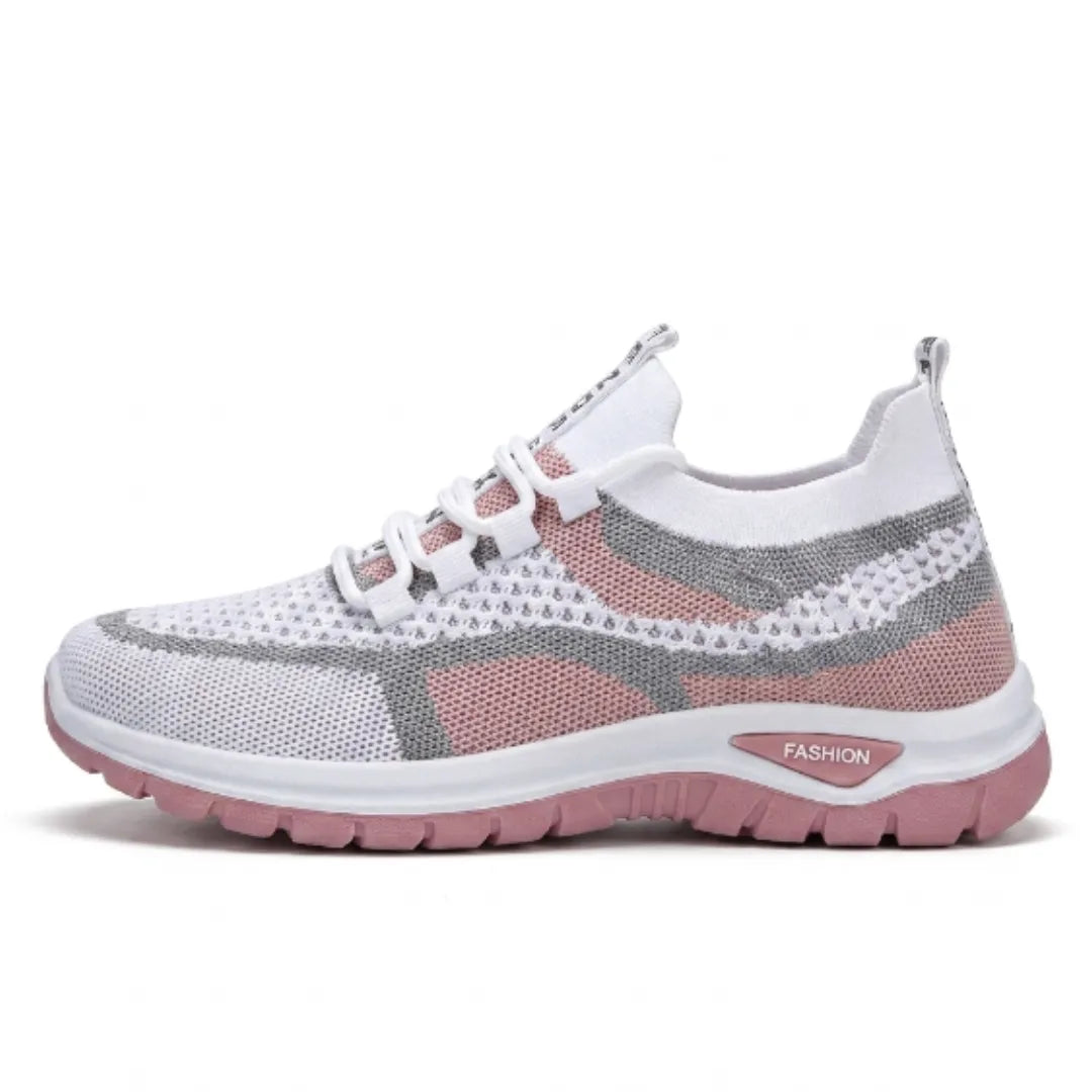 Side view of the white mesh trainer in a dusky pink colourway with grey overlays and a pink sole. 19