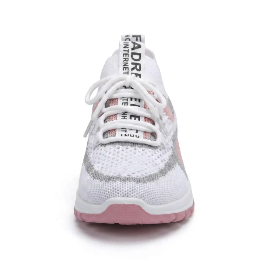 Front view of a white and pink knit trainer with white laces, showing the rounded toe and pink sole. 26