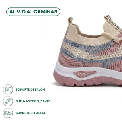 Close-up of the heel of a beige, pink and grey mesh trainer, with icons for heel support, grip and arch support. 31