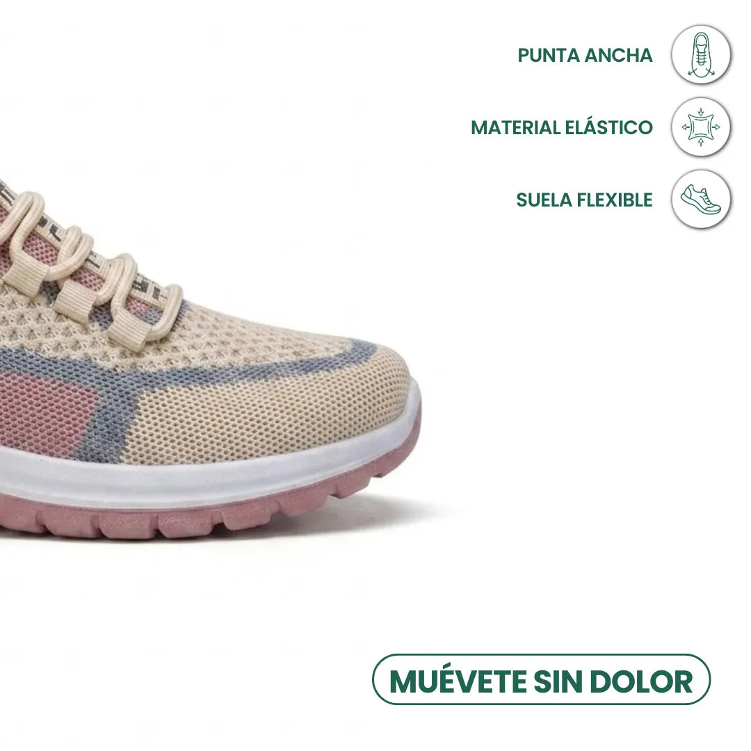 Close-up of the wide toe box of a beige, pink and grey mesh trainer, with icons for stretch material and flexible sole. 32