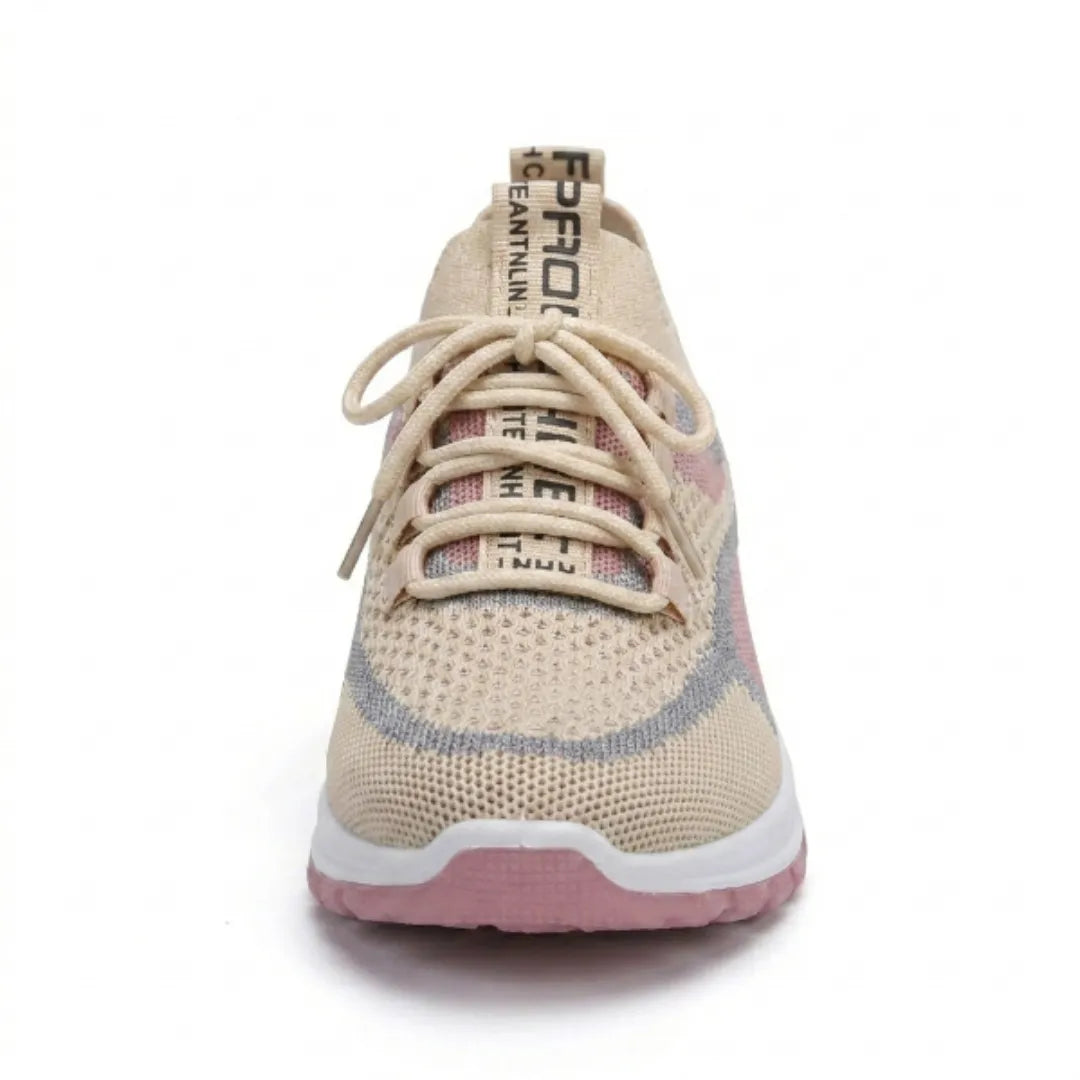 Front view of a beige knit trainer with pink and grey accents, beige laces and a pink sole. 35