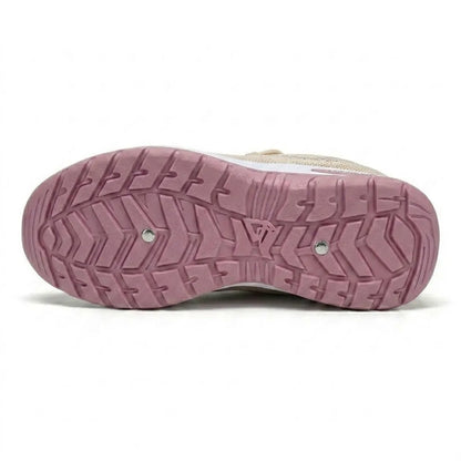 Underside of a pink trainer sole with chevron tread pattern and two small metal studs, with beige upper just visible. 36