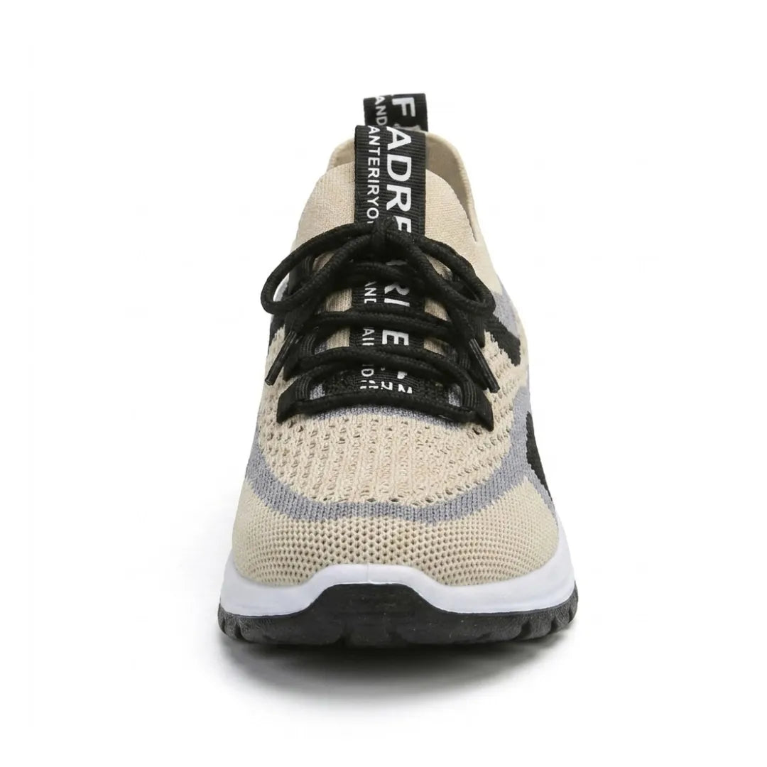 Front view of a single beige knit trainer showing the rounded wide toe, black laces, grey and black trim and chunky white and black sole. 44