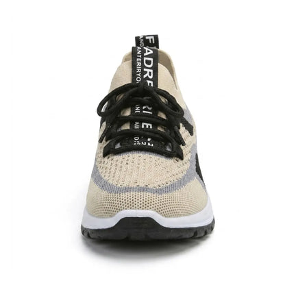 Front view of a single beige knit trainer showing the rounded wide toe, black laces, grey and black trim and chunky white and black sole. 44