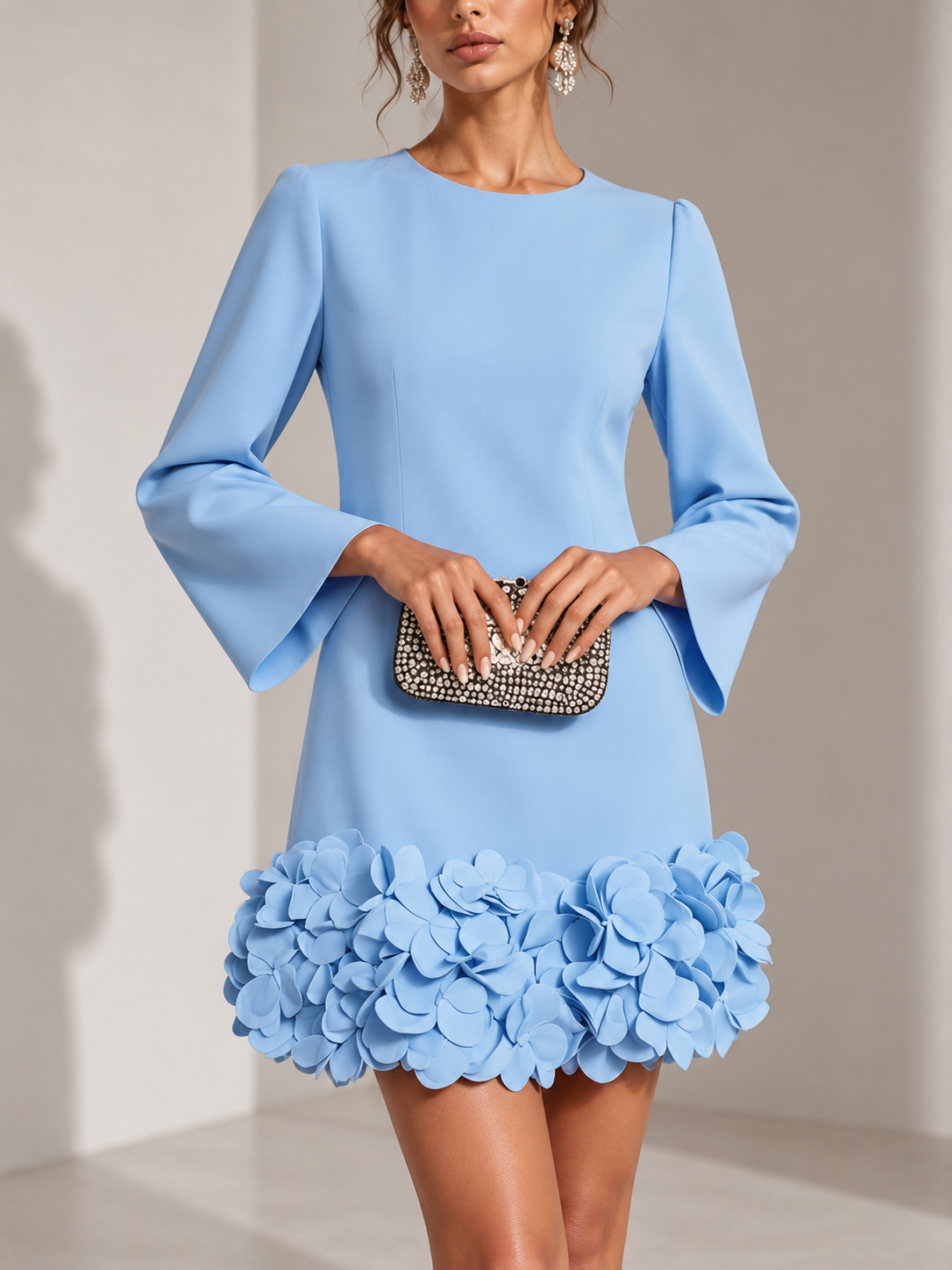 Pale blue version of the dress in a close front view, with flared sleeves and a hem of 3D petals. 5