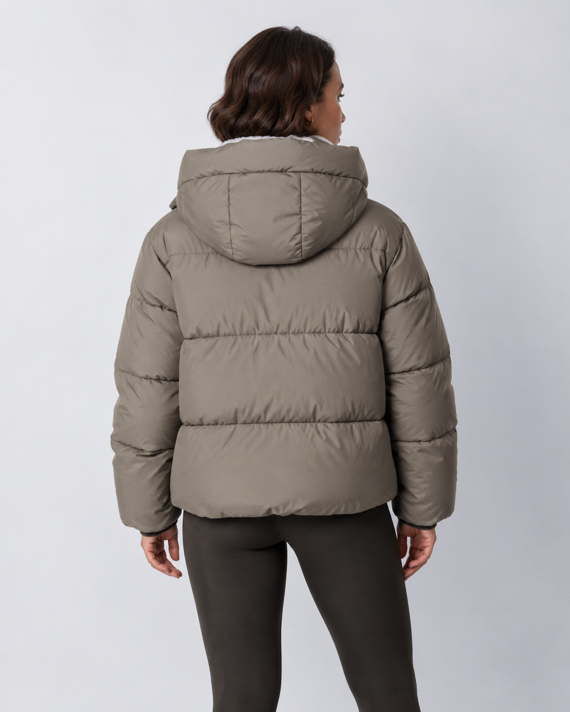 Back view of a taupe-grey puffer jacket with the hood up, showing the quilted back panels 20