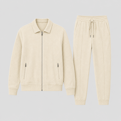 Flat lay of the cream jacket with zipped pockets beside the drawstring trousers with ribbed cuffs 6