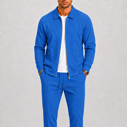 Model wearing the bright blue waffle-textured zip jacket and matching trousers over a white t-shirt 5