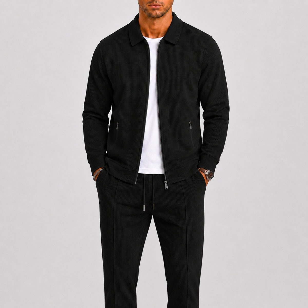 Model wearing the black waffle-textured zip jacket and matching trousers over a white t-shirt 3