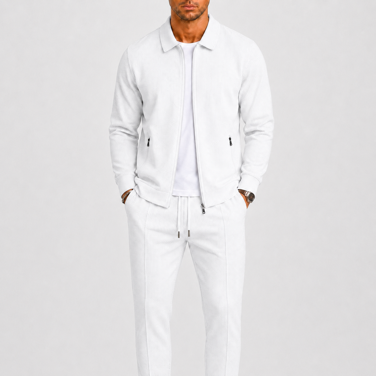Model wearing the white waffle-textured zip jacket and matching trousers over a white t-shirt 2