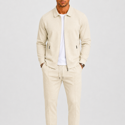 Model wearing the cream waffle-textured zip jacket and drawstring trousers over a white t-shirt 1