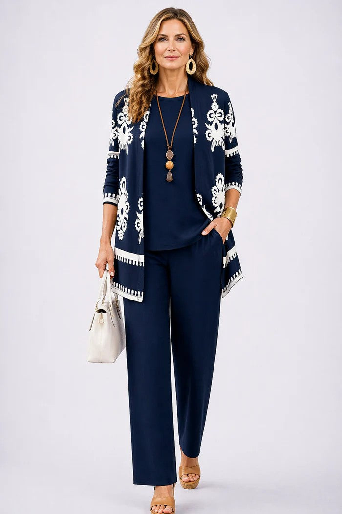Model in a navy set with a white ornate-motif print and trim on the cardigan 7